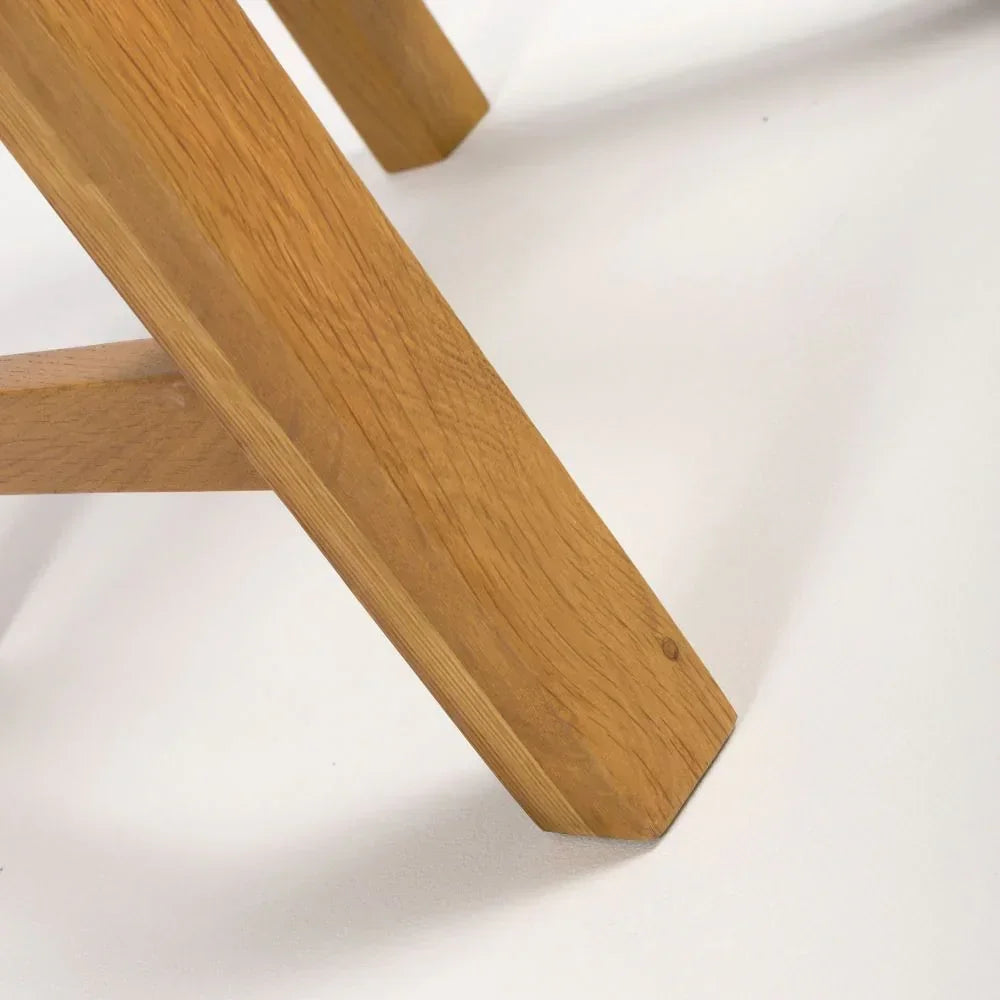 Oak dining table leg with angled support on white background