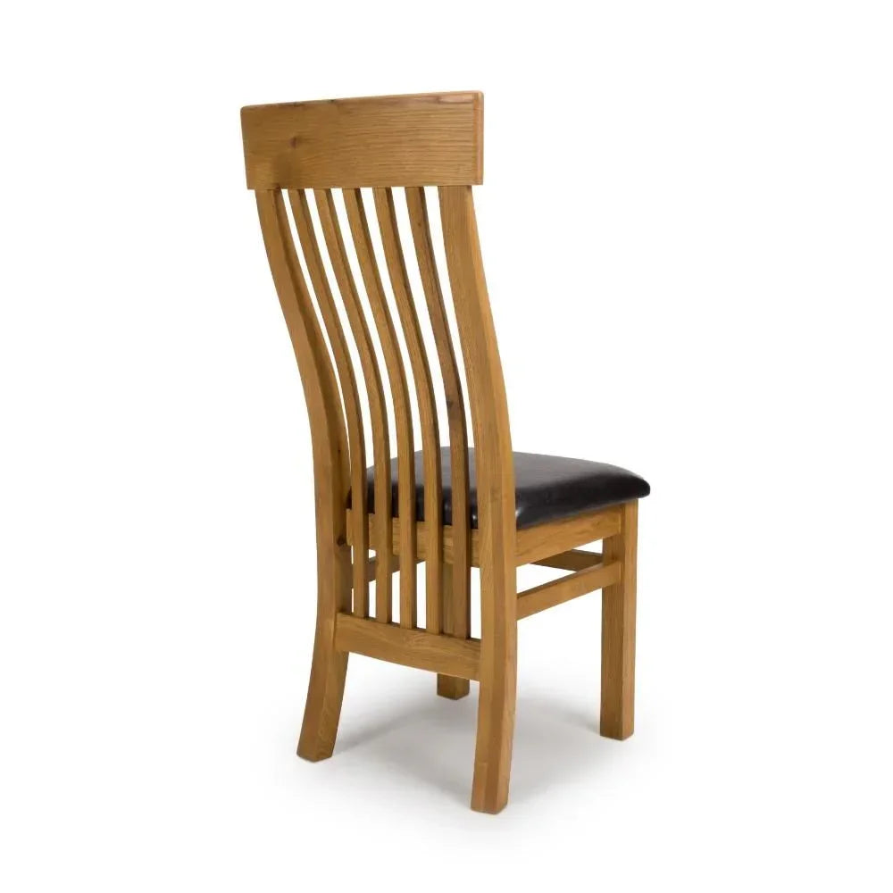 Oak dining chair with slatted back and black cushioned seat, rear angle view