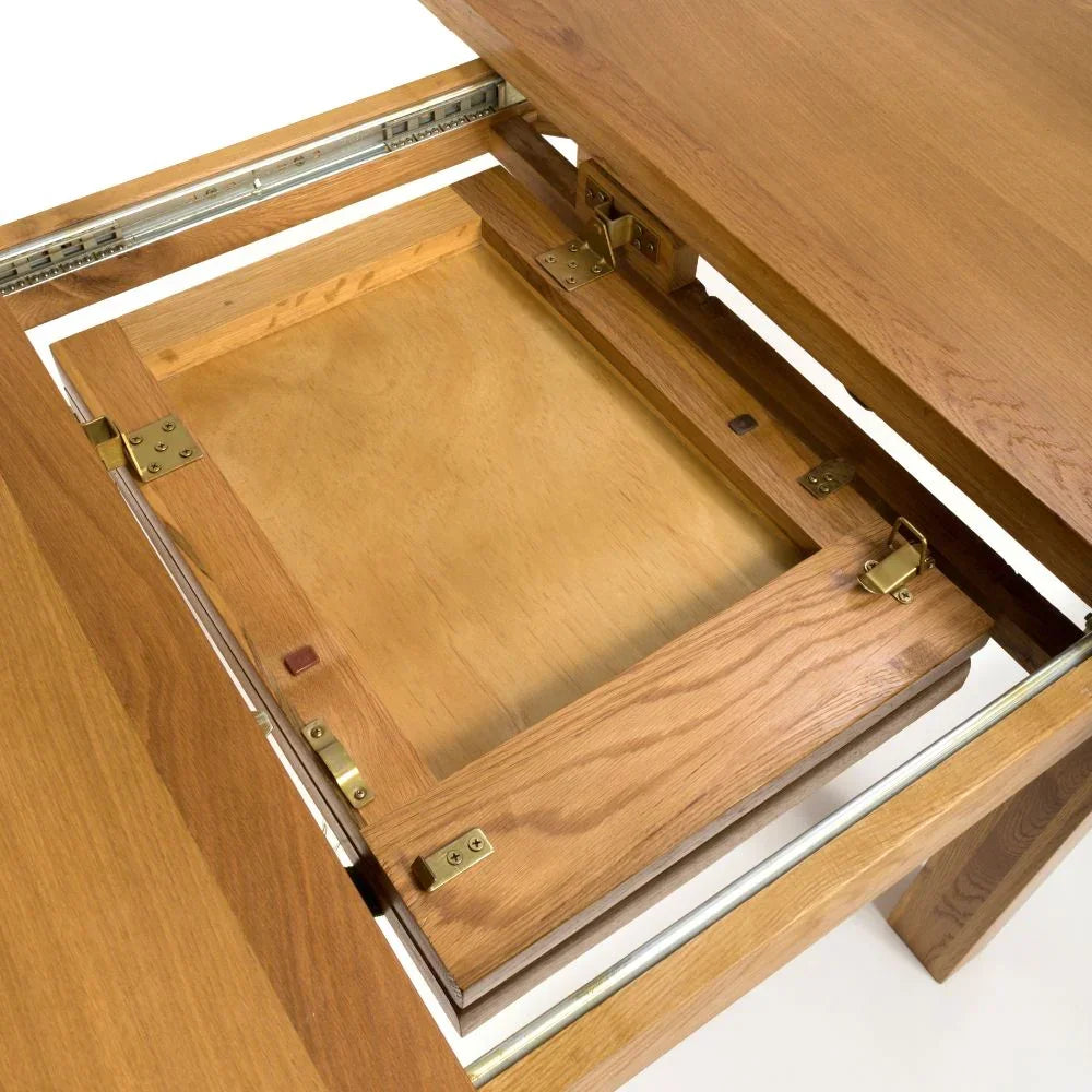 Oak extending dining table closeup showing metal runners and folding leaf mechanism
