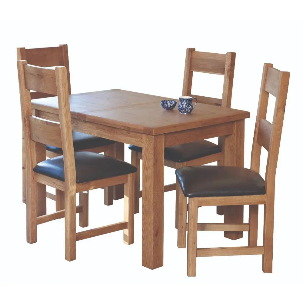 Oak dining table with four matching chairs and faux leather seats
