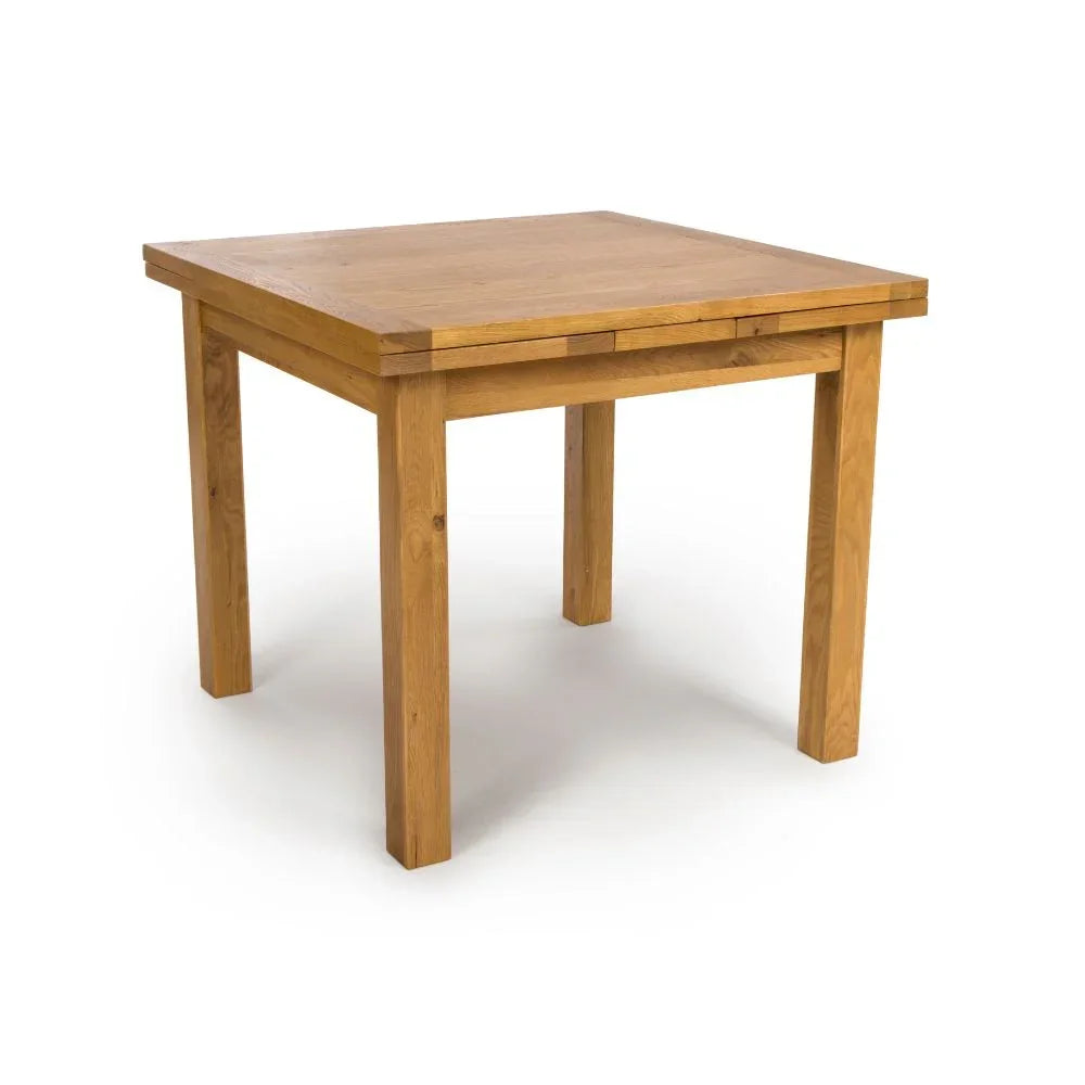 Square oak dining table with natural wood grain and chunky legs on white background
