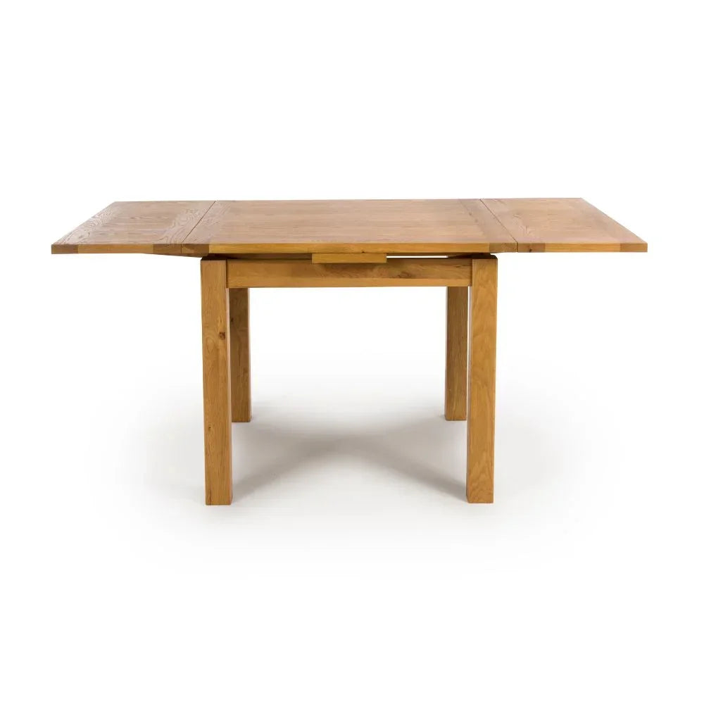 Rectangular oak dining table with extended leaves, shown from the front on white background