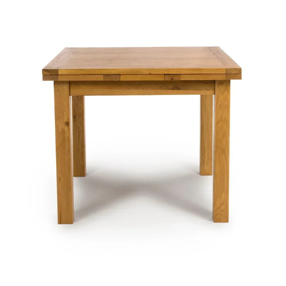 Solid oak dining table with straight legs and rectangular top, photographed front on