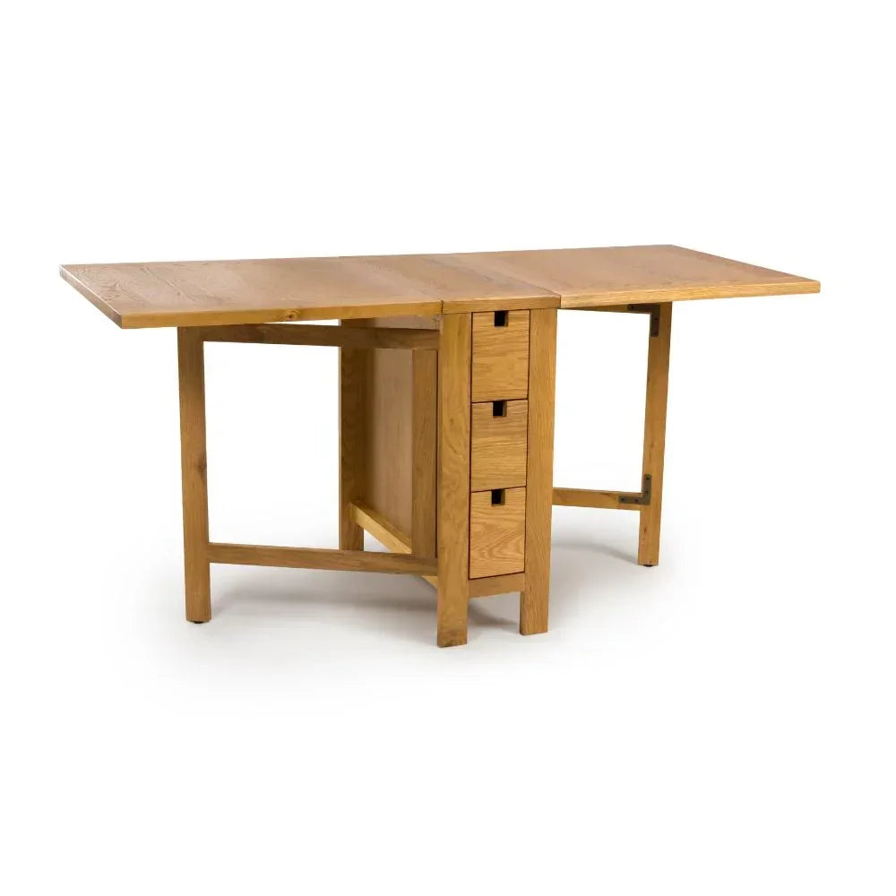 Extendable oak dining table with three drawers and drop-leaf sides, shown open
