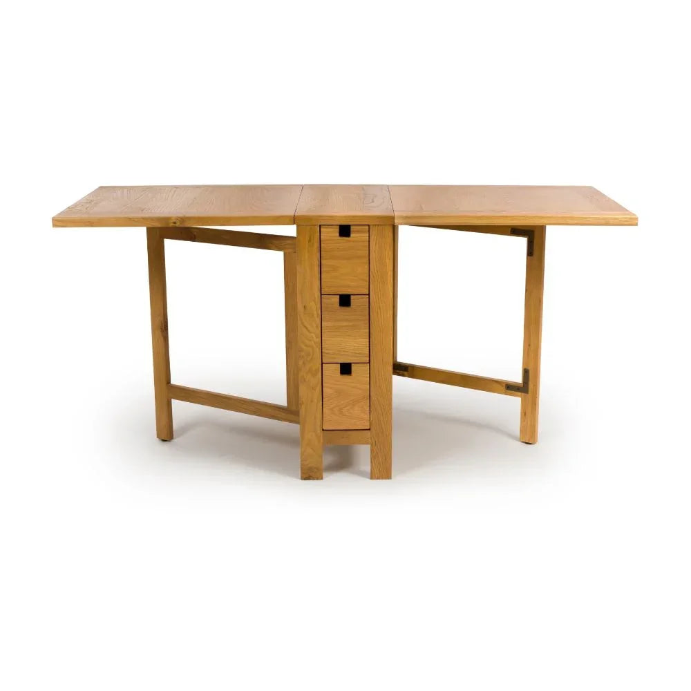 Oak folding dining table with three central drawers and extended leaves