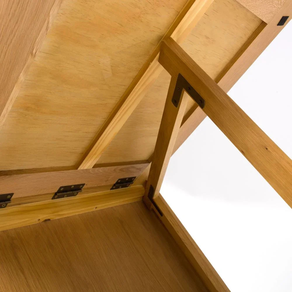 Oak storage bench lid showing metal hinges and internal wooden frame close-up