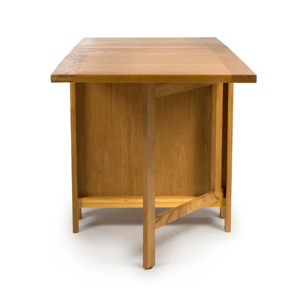 Solid oak dining table with rectangular top, shown from end view highlighting wood grain