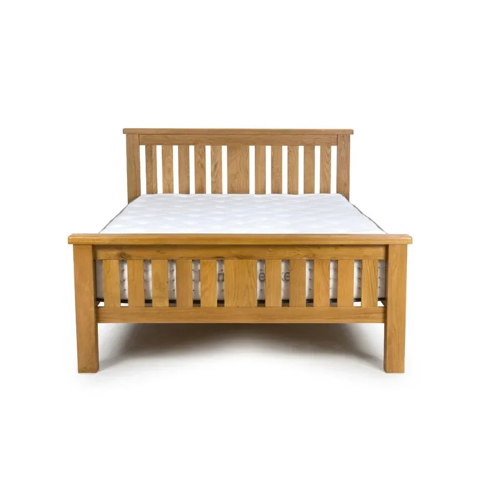 Solid oak bed frame with vertical slat headboard and footboard, mattress included