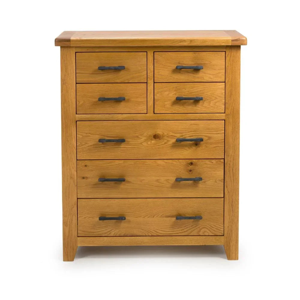 Oak chest of drawers with black handles, seven drawer storage unit on white background