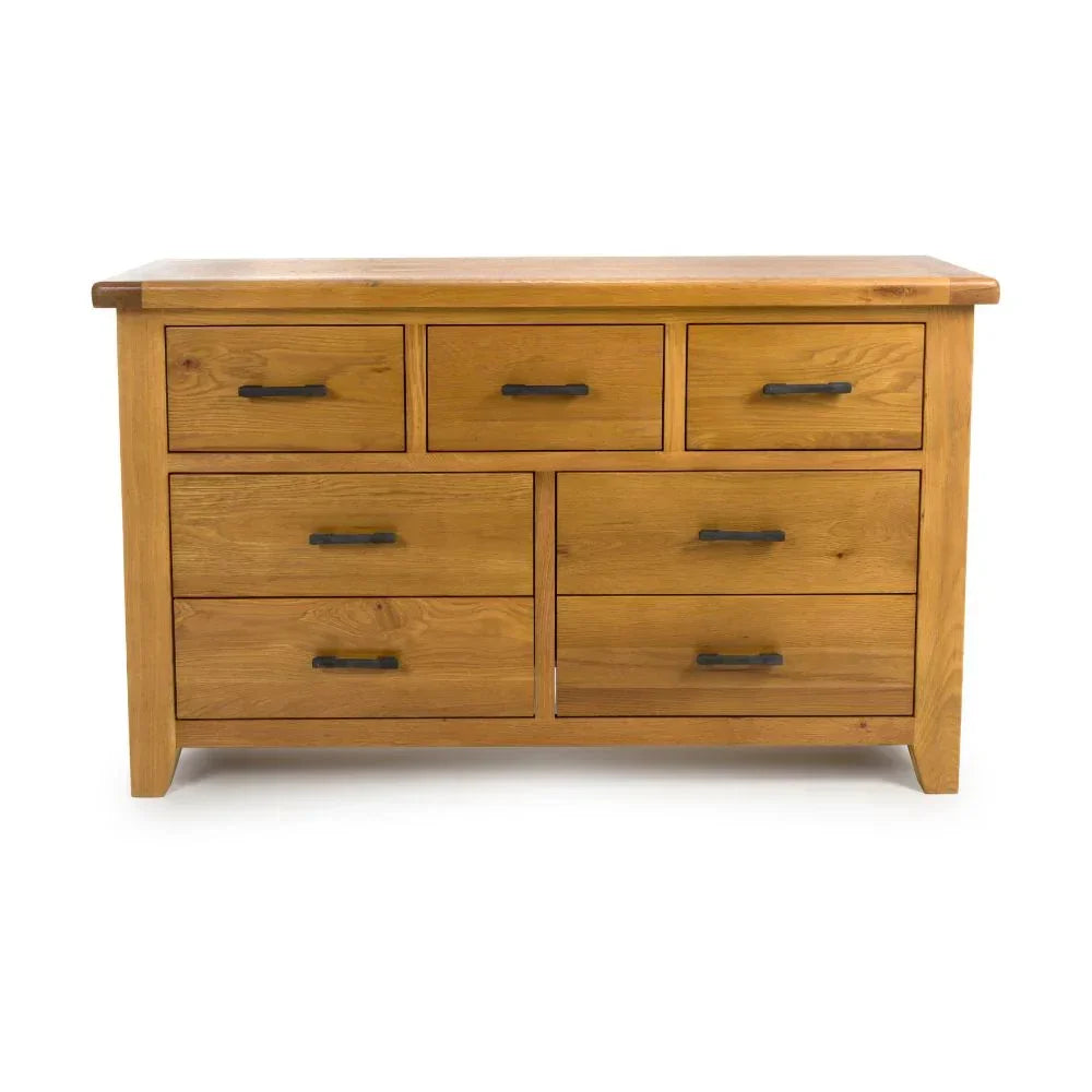 Oak chest of drawers with seven compartments and black metal handles on white background