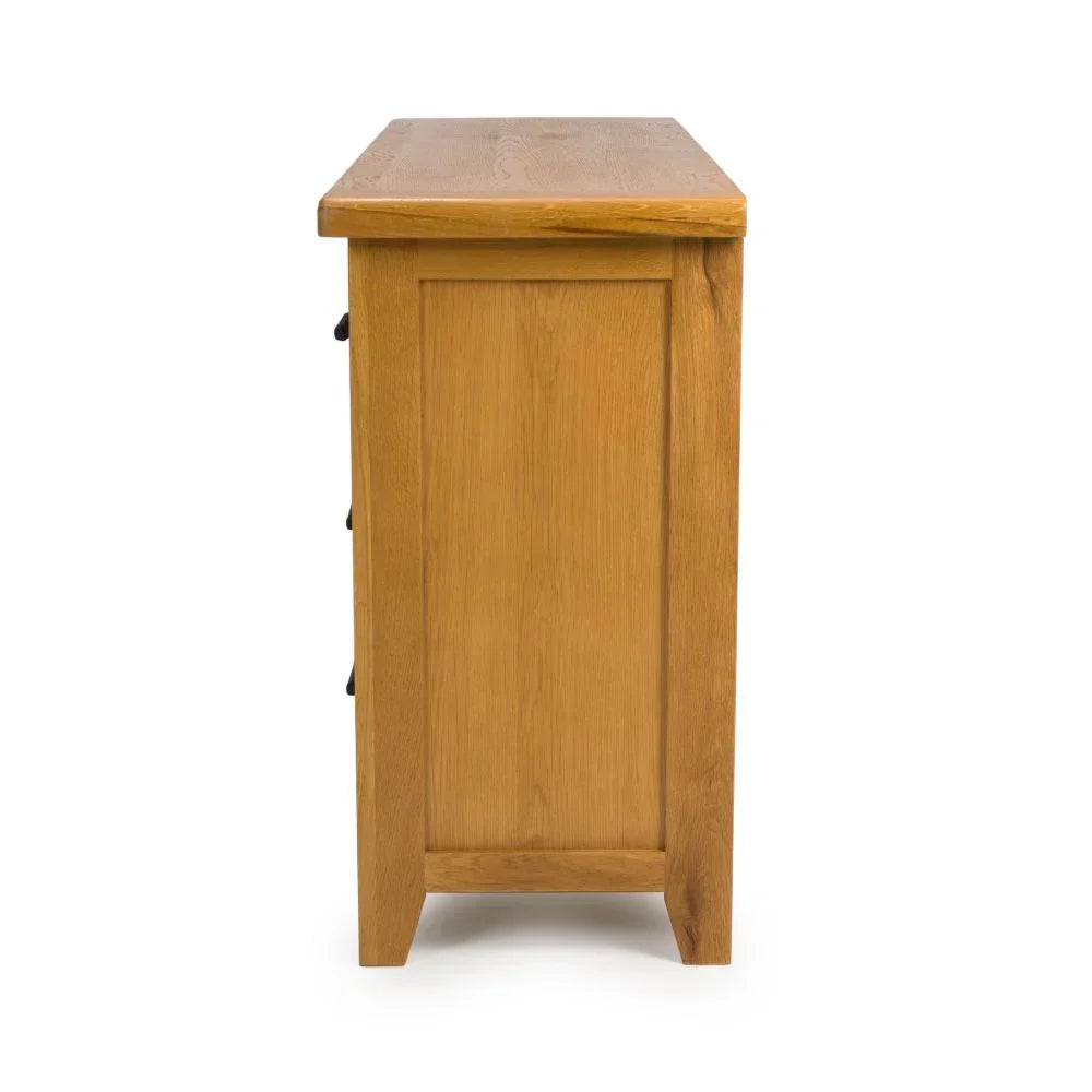 Side view of oak chest of drawers with simple panelled design