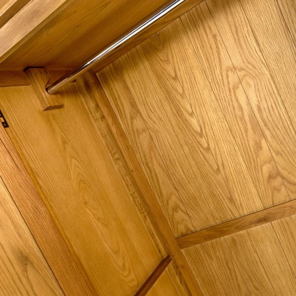 Solid oak wardrobe interior with hanging rail and panelled wood finish