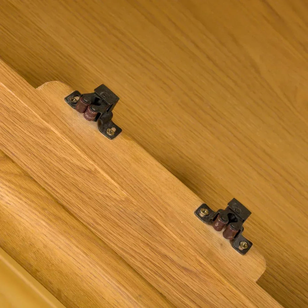 Close-up of oak furniture cabinet door catch with metal latch fitting