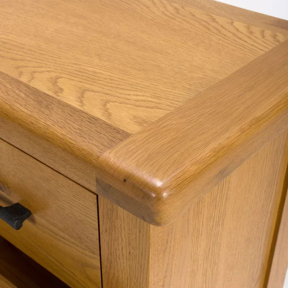 Solid oak furniture corner detail with natural wood grain and smooth edge