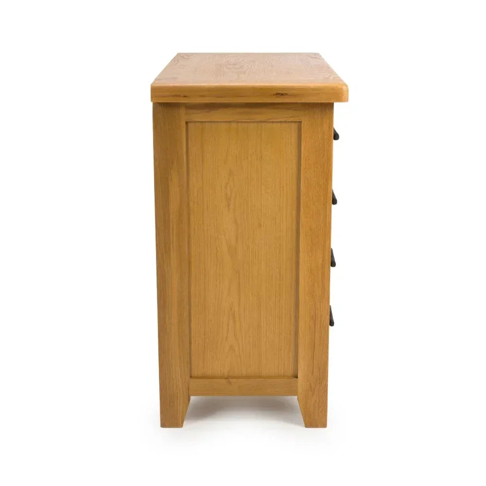 Side view of oak chest of drawers with smooth wood grain finish and panel detailing