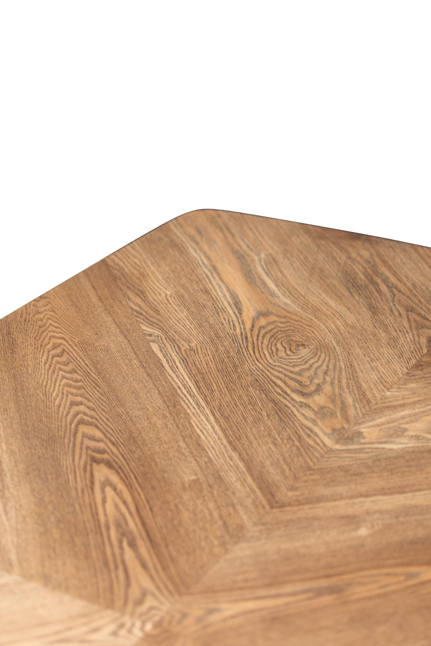 Close up of dining table corner with natural wood grain and chevron pattern