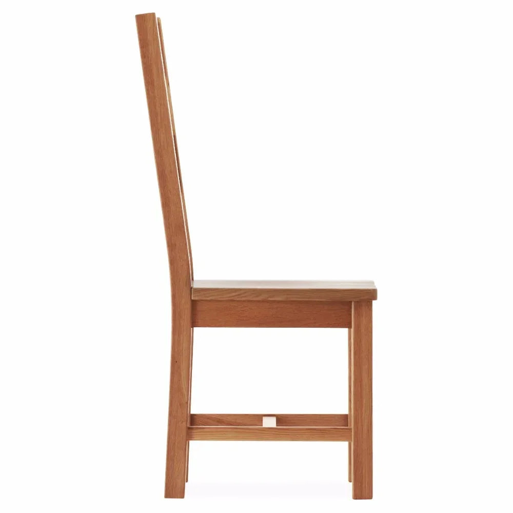 Side view of wooden dining chair with high back and natural finish