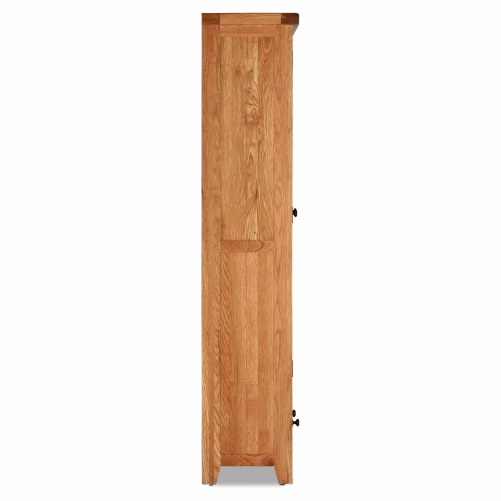 Side view of tall oak display cabinet with panelled door and metal handle