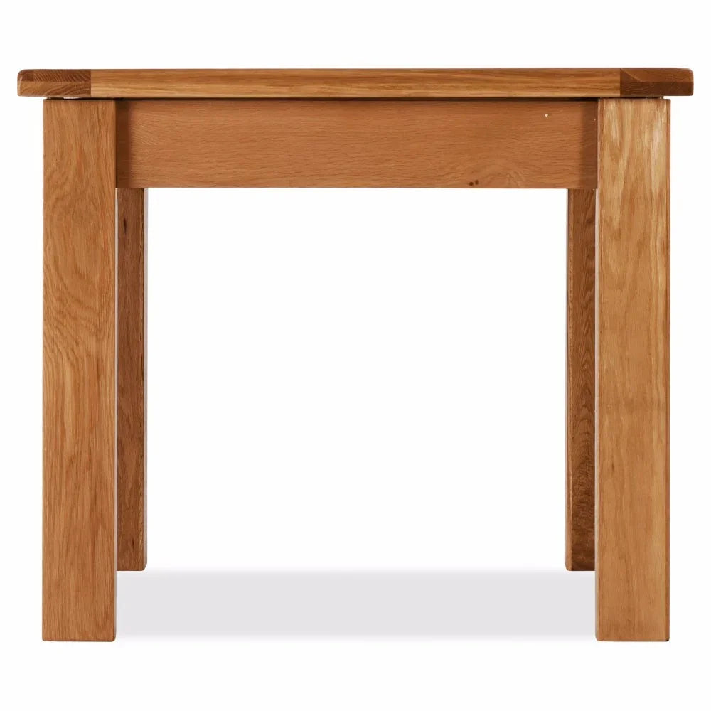 Solid oak dining table with thick legs and natural wood finish, front view