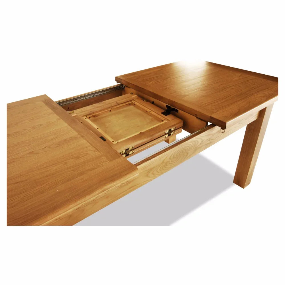 Oak extending dining table with visible extension mechanism and wooden legs