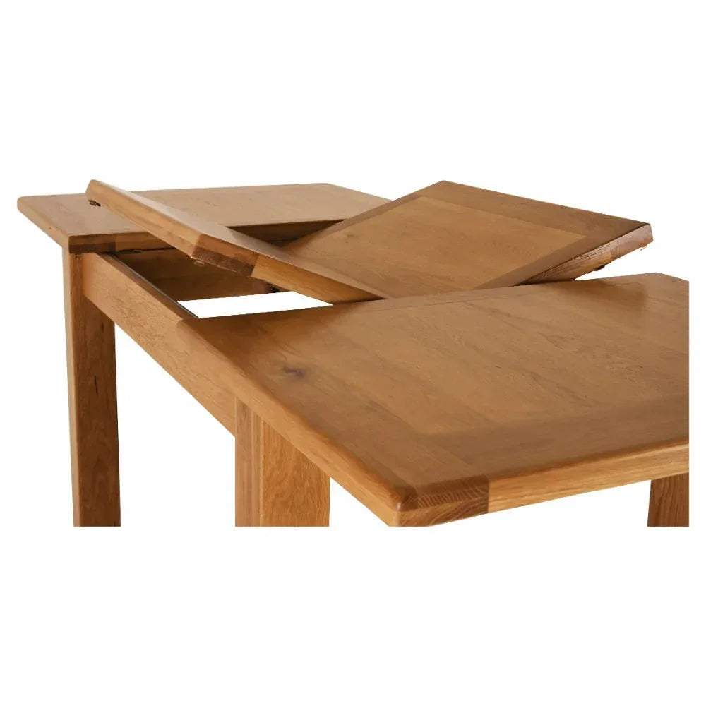 Oak extending dining table with butterfly leaf partially opened on white background