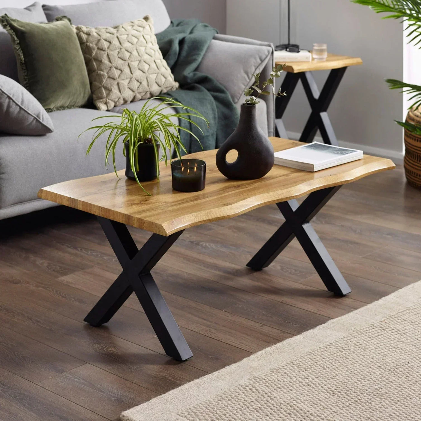 Wood coffee table with black metal legs in modern living room, styled with plants and decor