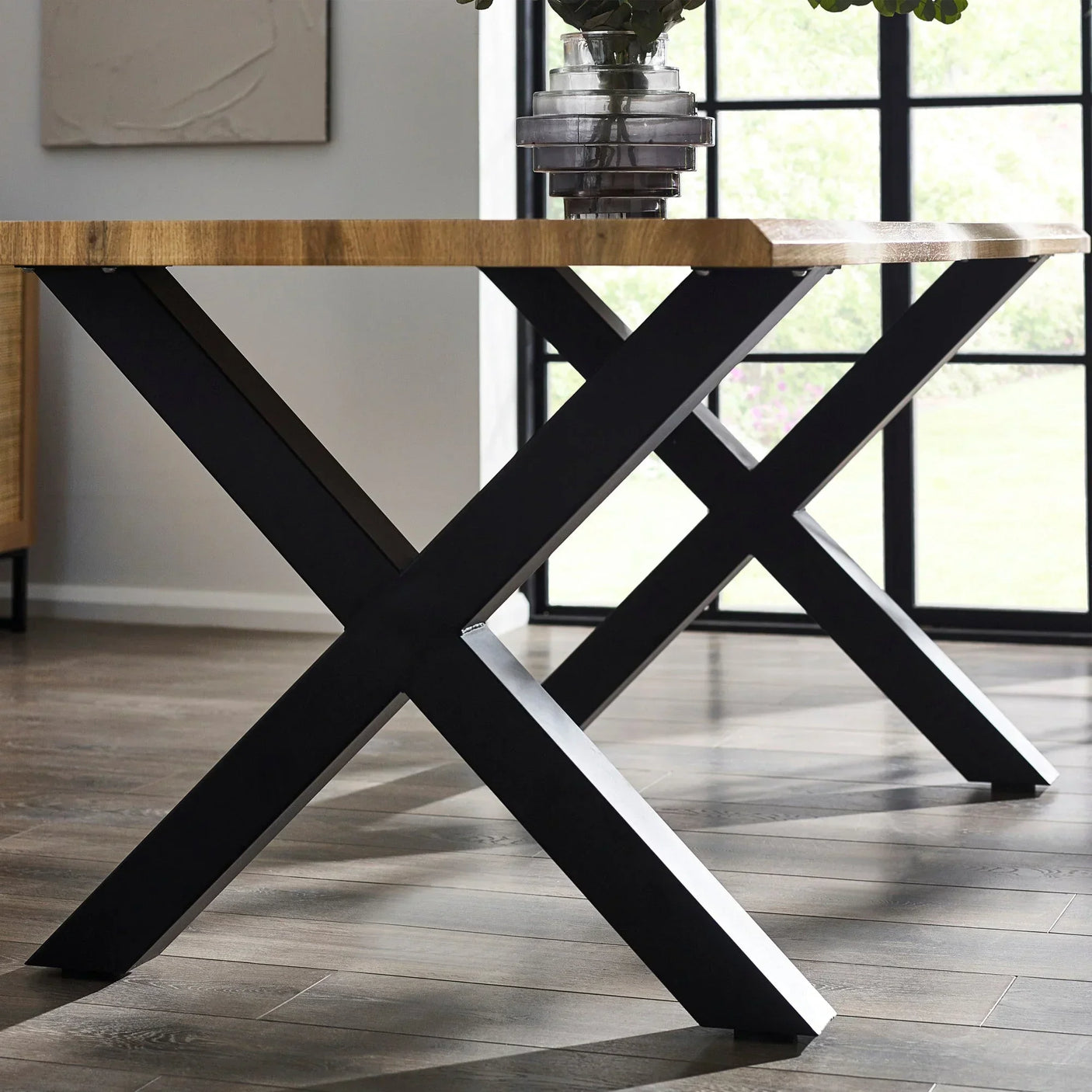 Harvey dining table with black metal legs and solid wood top in modern dining room