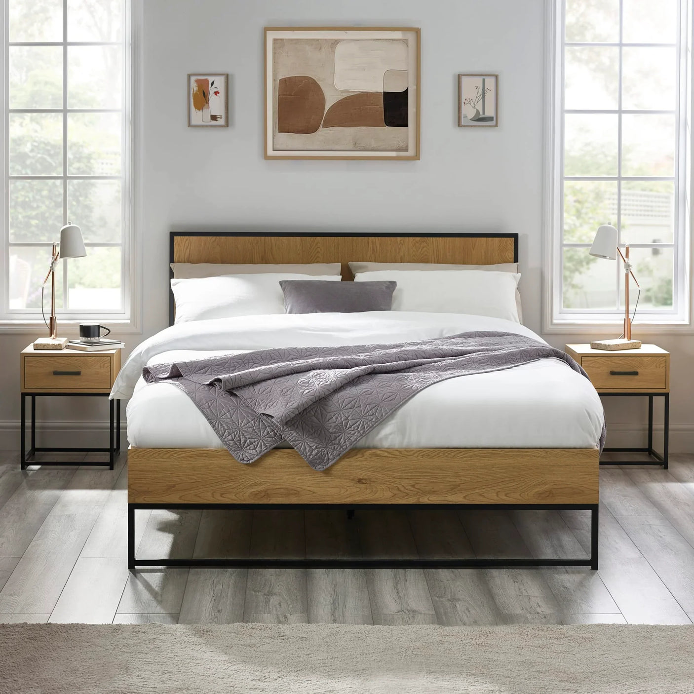 Oak and black metal bed frame with white bedding, matching bedside tables, modern decor