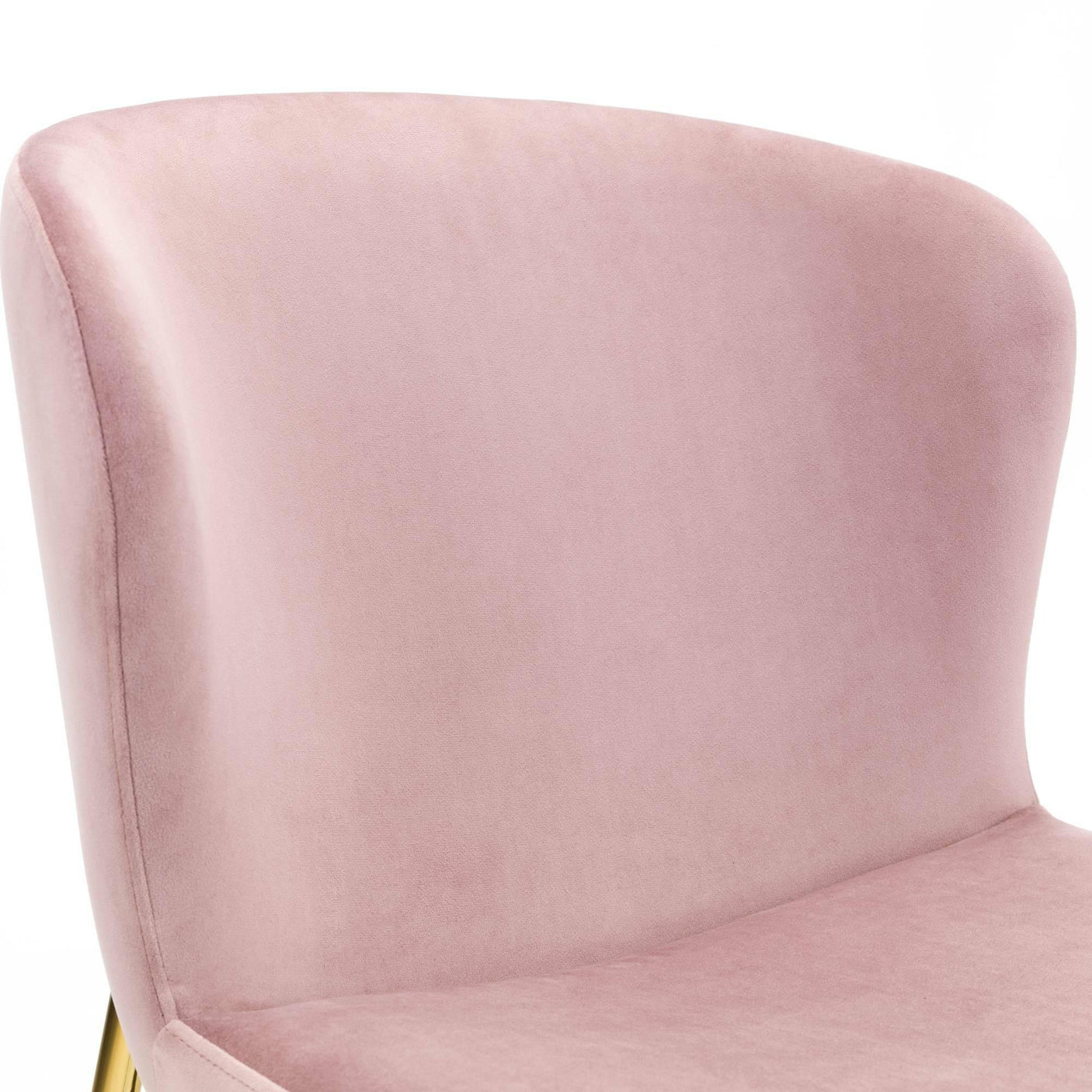 Blush pink velvet dining chair with curved backrest and gold legs, close-up view