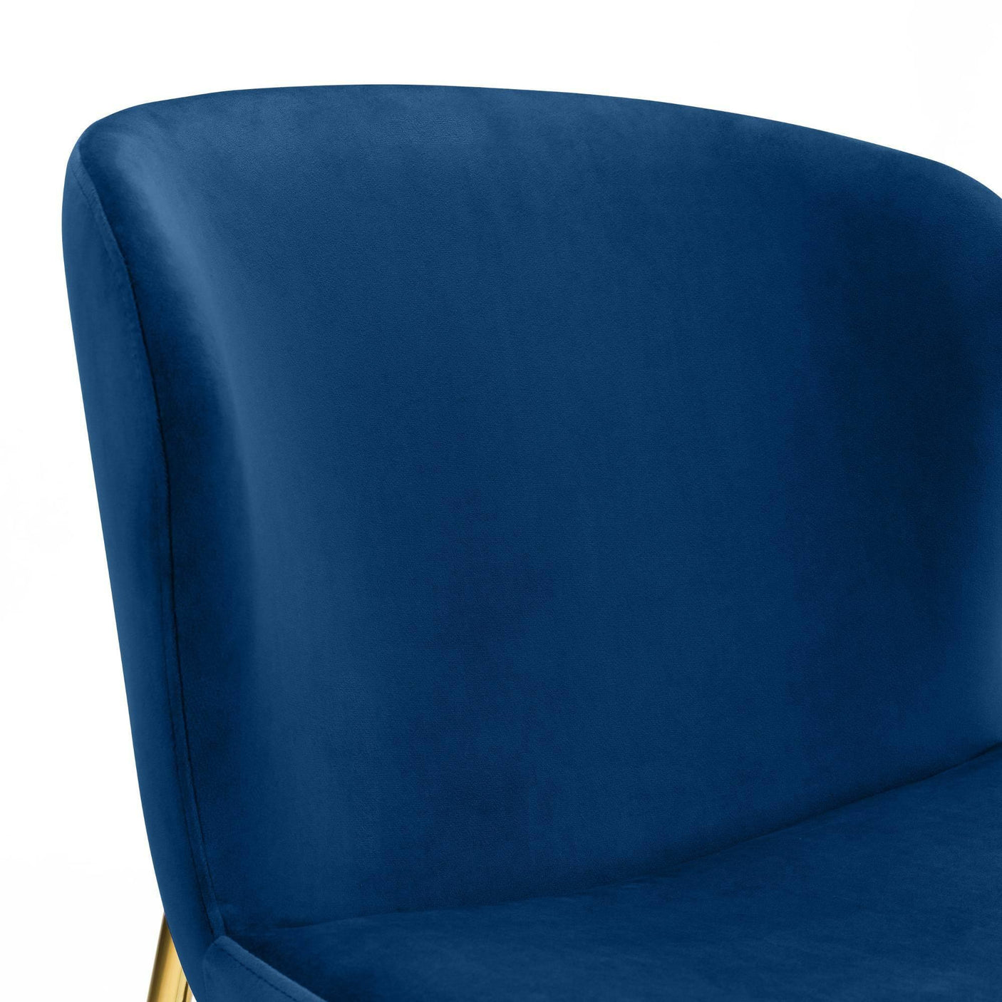 Close view of blue velvet chair backrest with curved design and smooth upholstery