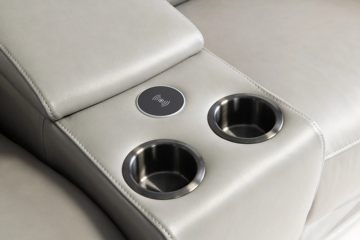 Grey leather console sofa armrest with wireless charging pad and two cup holders