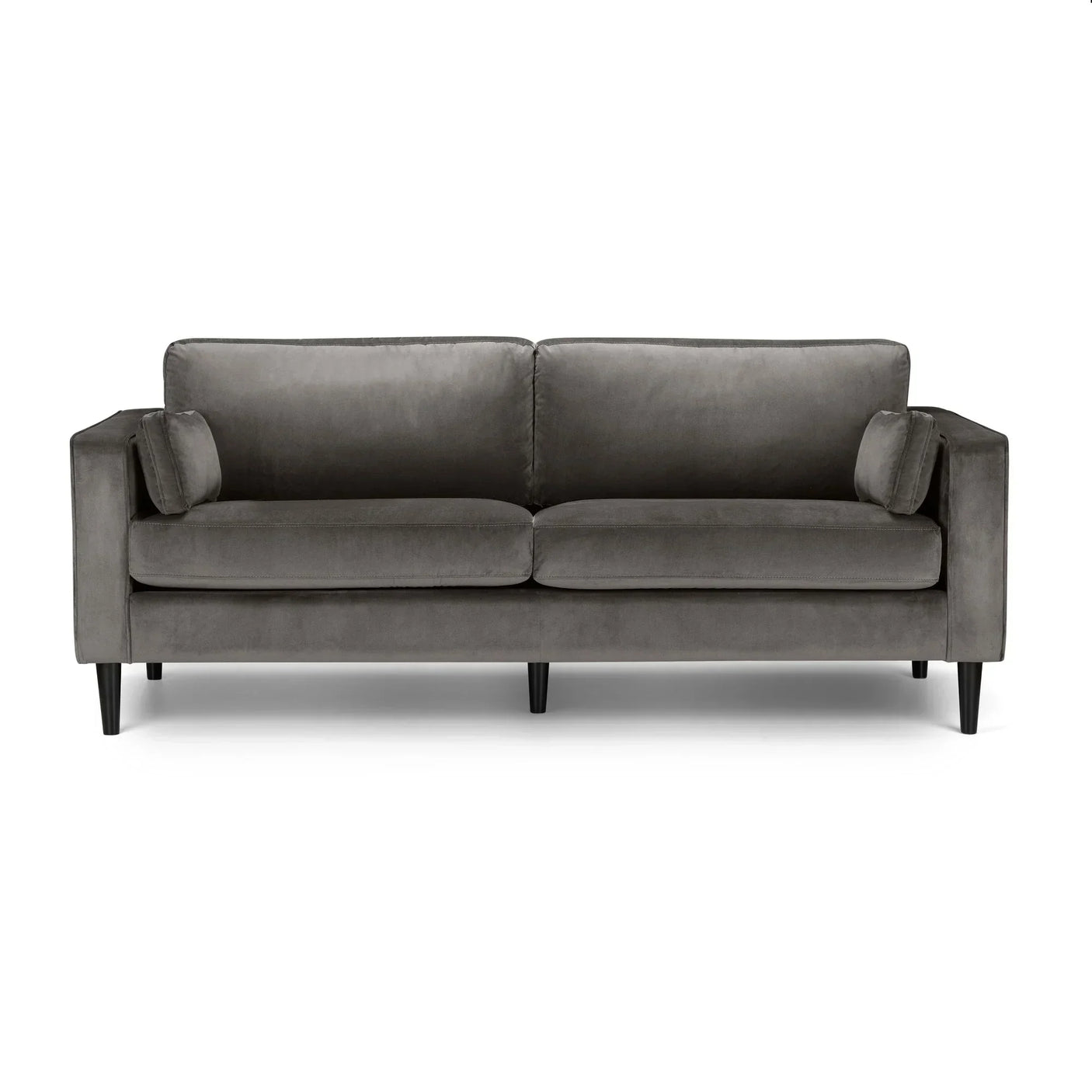 Grey velvet three seater sofa with slim black legs and matching bolster cushions, front view