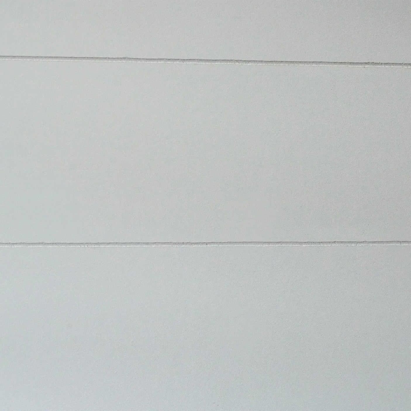 Light grey wooden panel detail from Hazel low sleeper bed, showing horizontal grooves