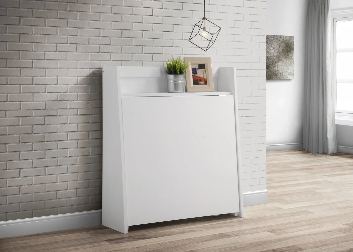 White compact folding dining set closed against wall with plant and photo frame on top