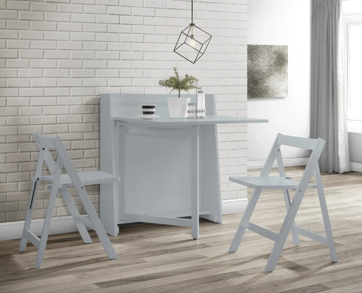 Light grey compact folding dining set with two chairs in modern room with brick wall