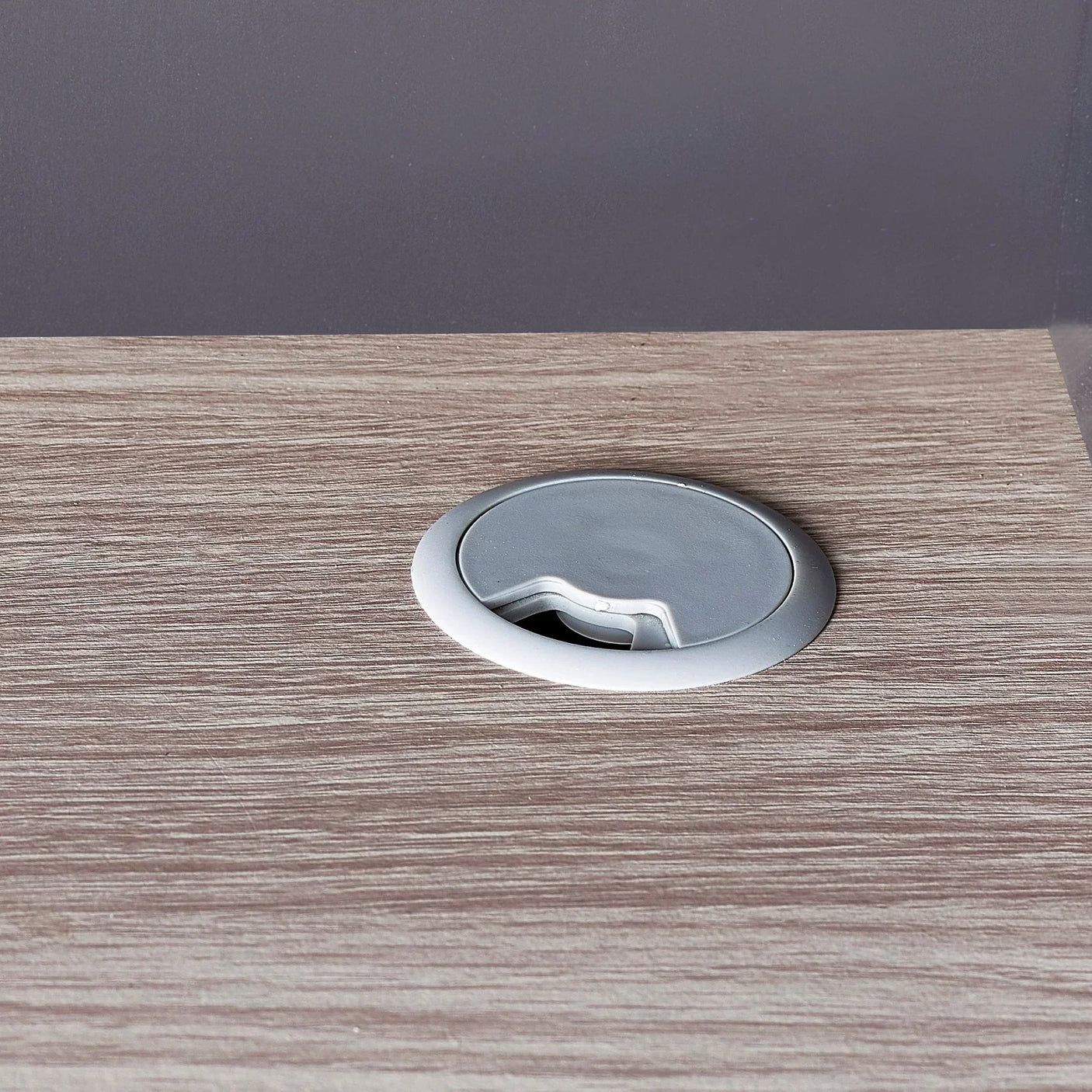 Woodgrain highsleeper desk with round cable management grommet in anthracite finish