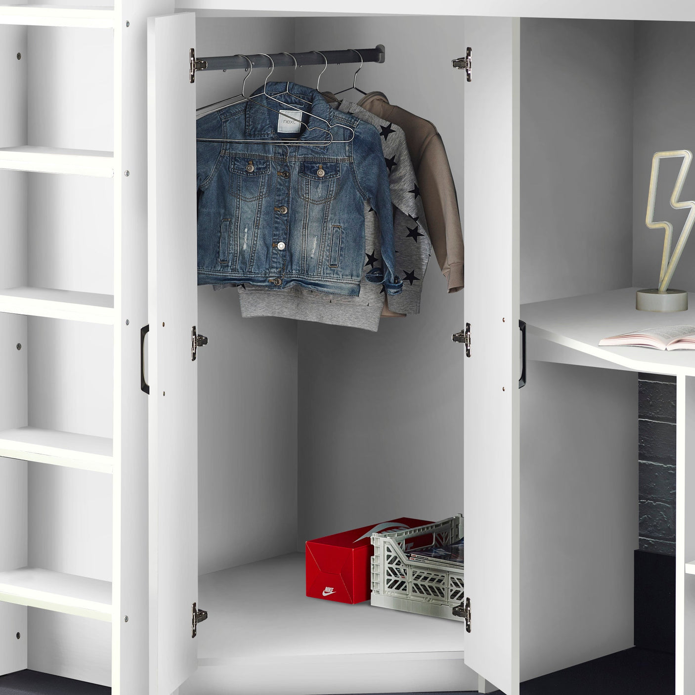 White wardrobe with hanging rail, open shelves, and integrated desk in modern bedroom