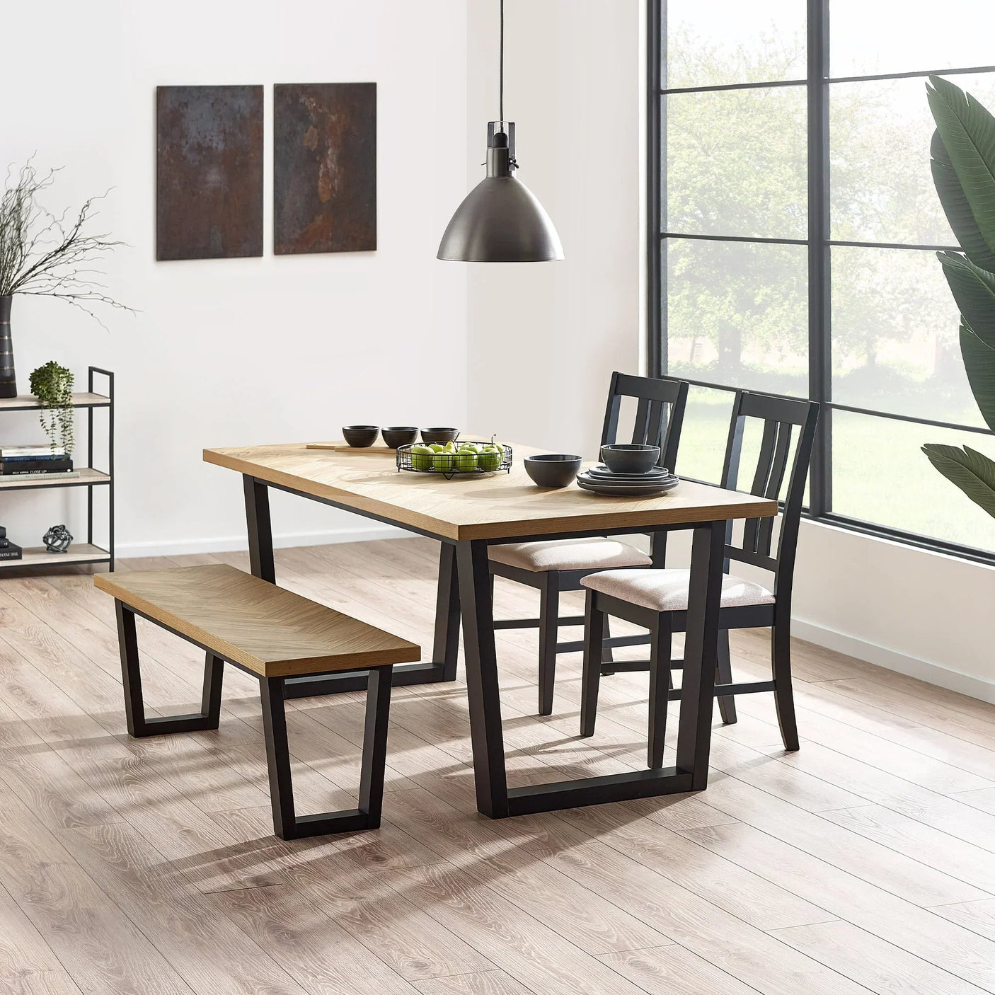 Hilton dining chair with black frame and light cushioned seat at wooden dining table set