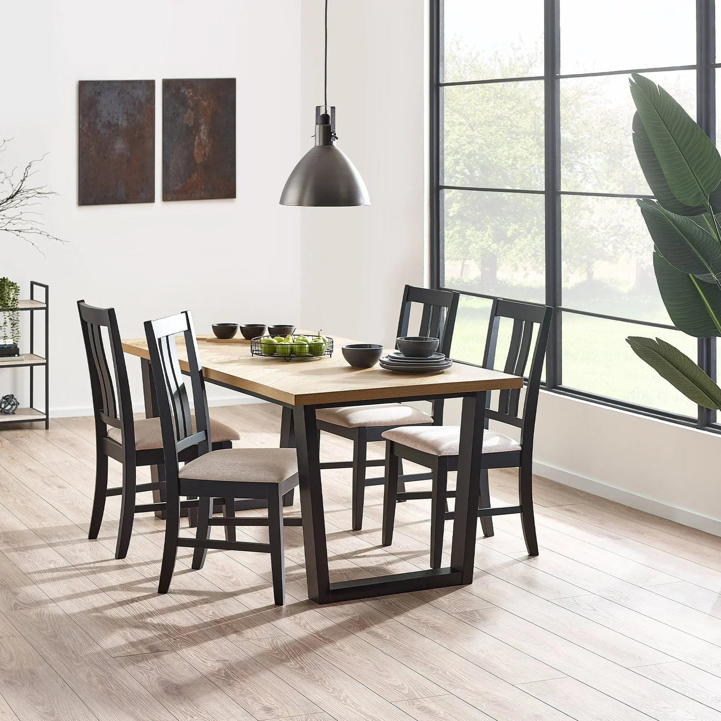 Hilton dining chairs with black frames and cushioned seats around wood dining table