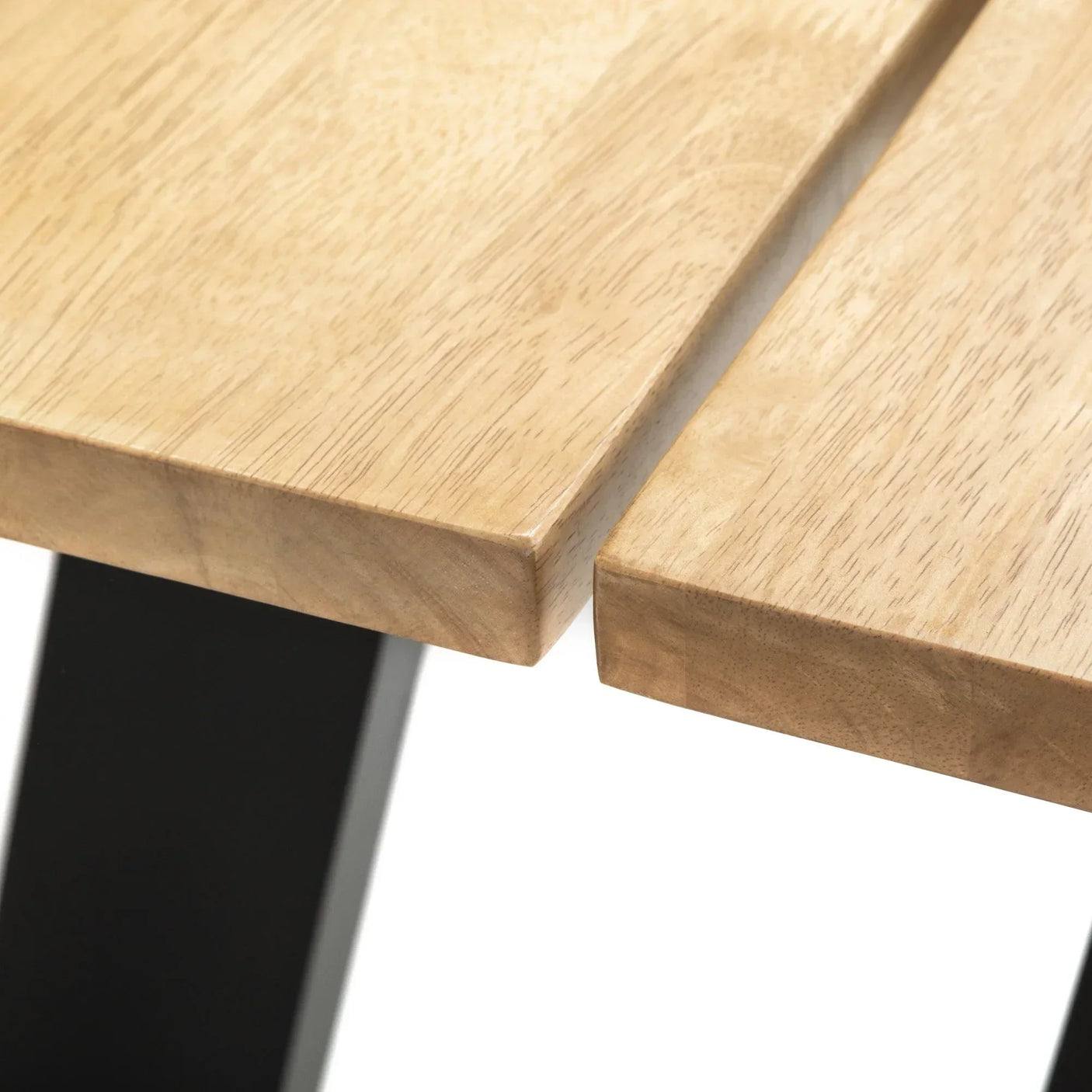 Close-up of light wood dining table top with two planks and black metal legs