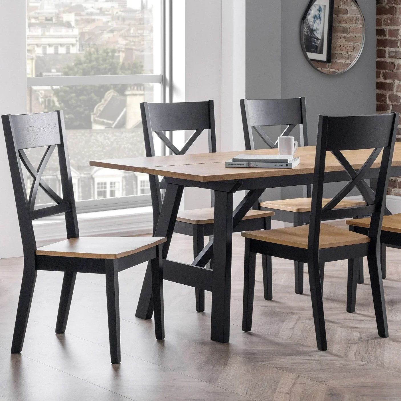 Black and oak dining chairs with slatted backs around matching wood table in modern room