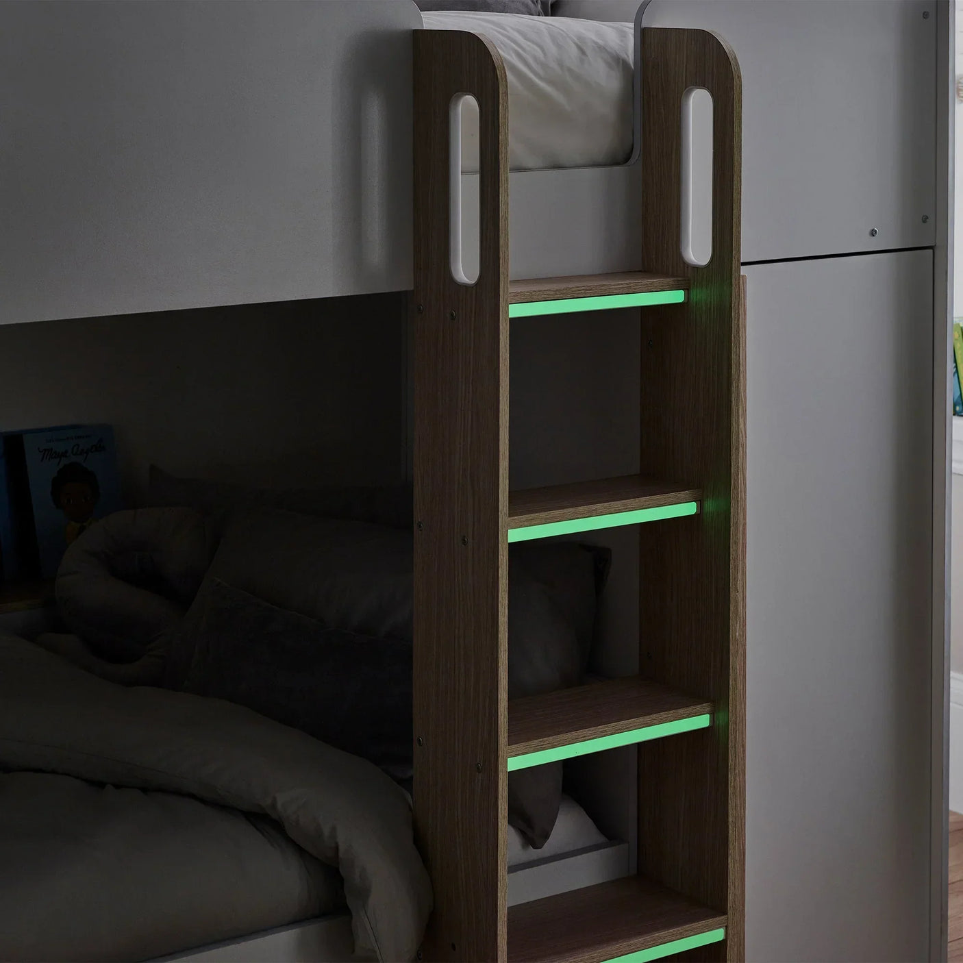 Pale wood bunk bed ladder with integrated glow-in-the-dark steps and grey bedding