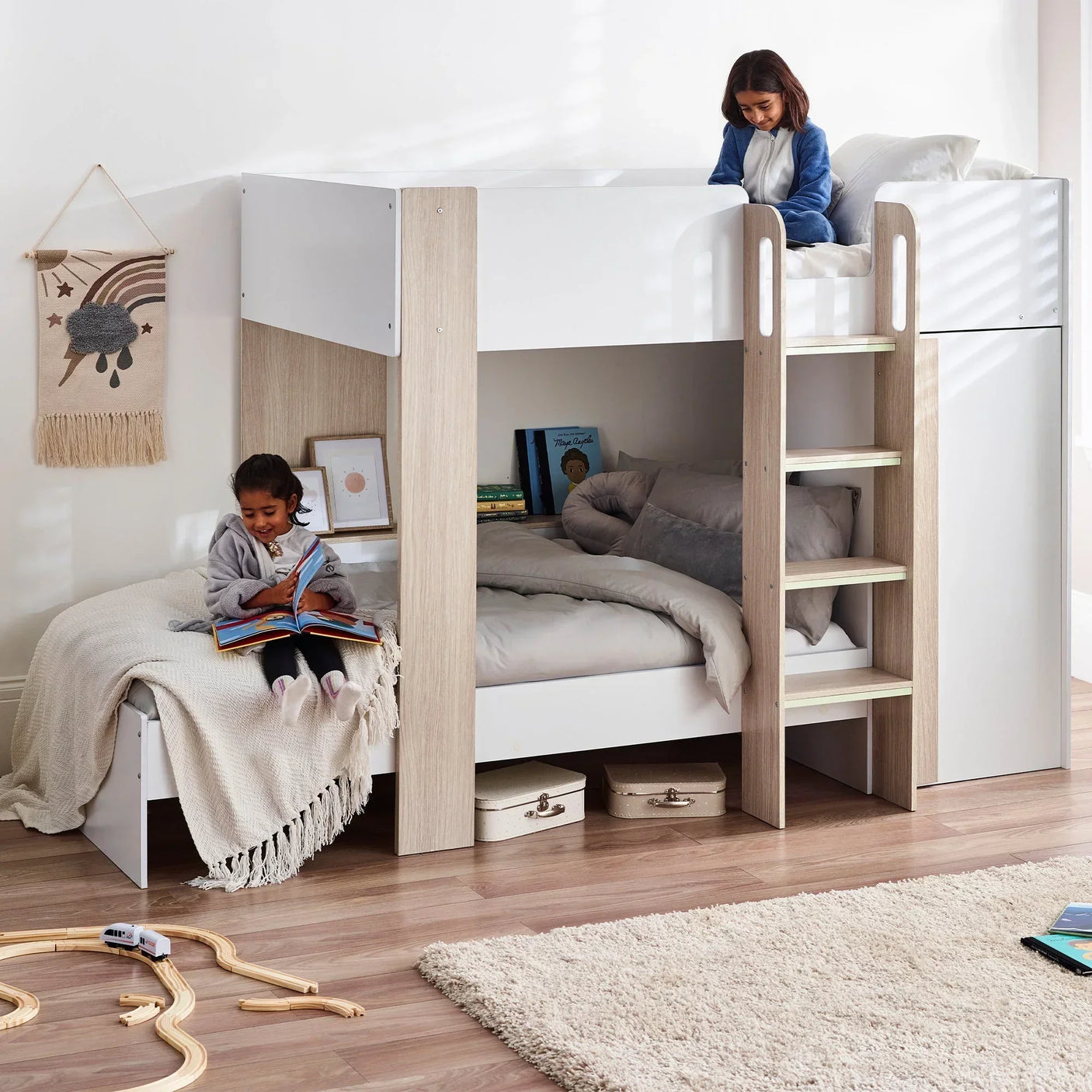 Pale wood and white bunk bed with ladder, styled in a bright children's bedroom