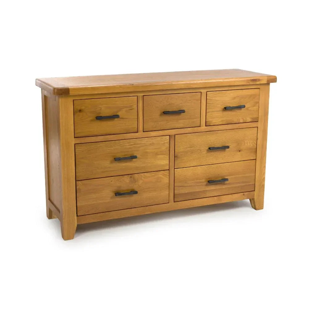 Oak chest of drawers with seven black metal handles and natural wood grain finish