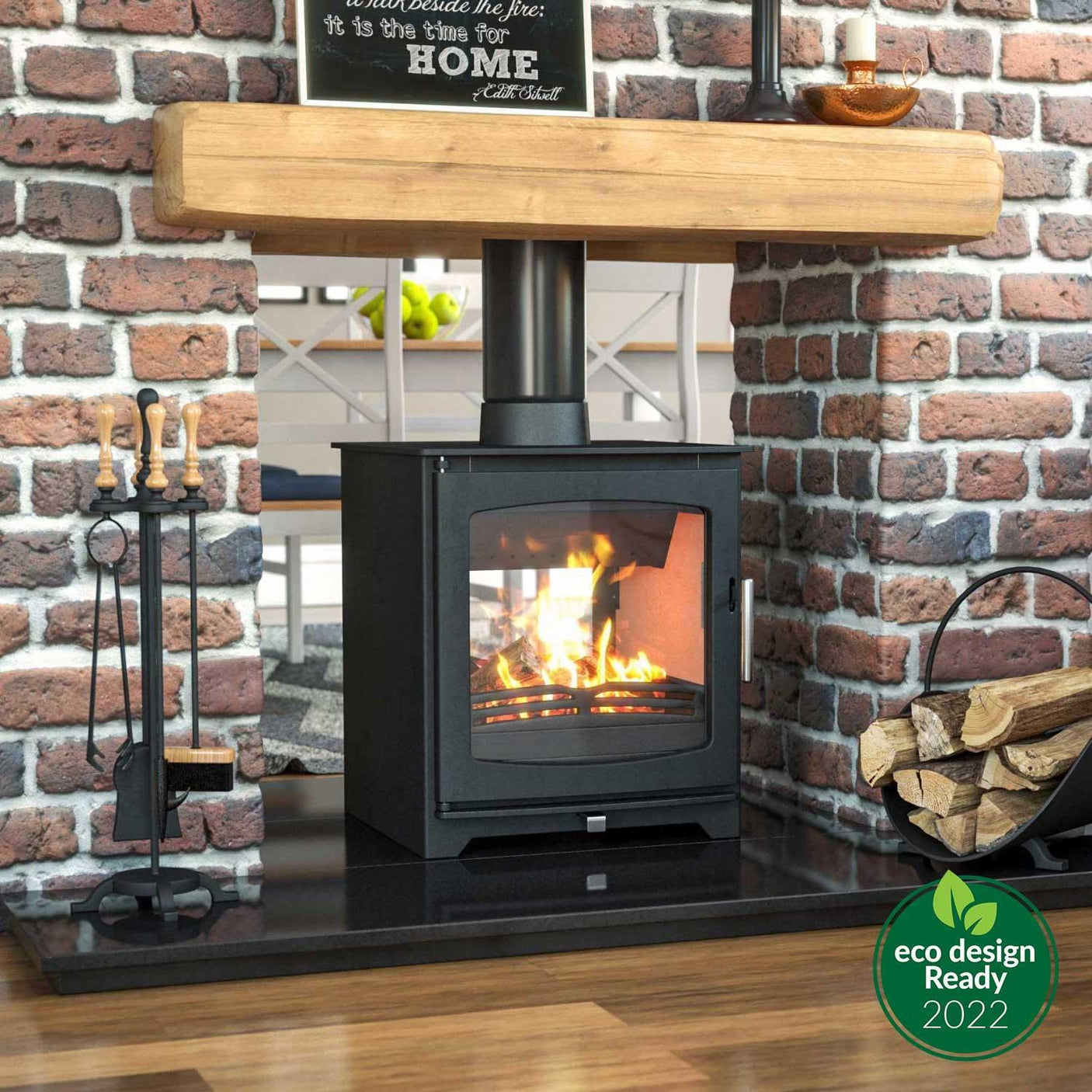 Hazelwood wood burning stove with glass door on black hearth, brick surround, and fire tools