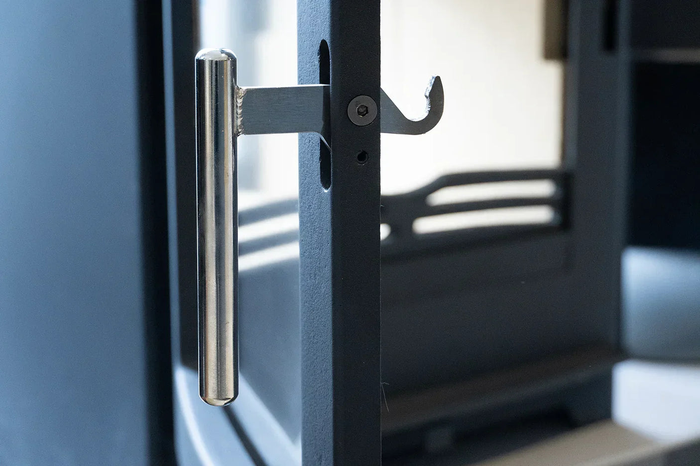 Hazelwood stove handle and hook latch close-up in brushed metal finish