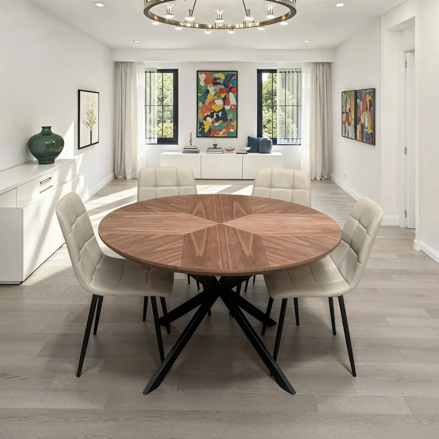 Round wood dining table with four taupe PU chairs in a bright modern dining room
