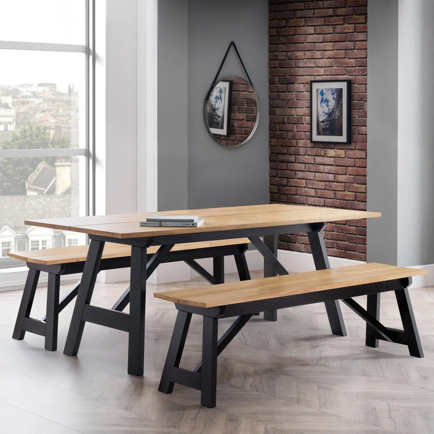 Oak dining table with black metal legs and two matching benches in modern dining room