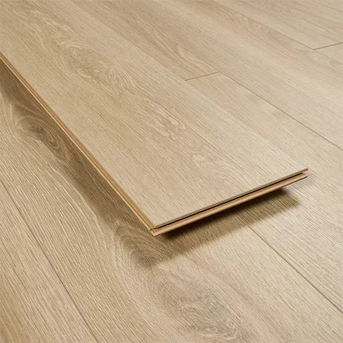 Light oak laminate flooring plank with wood grain detail, close up angle on floor surface