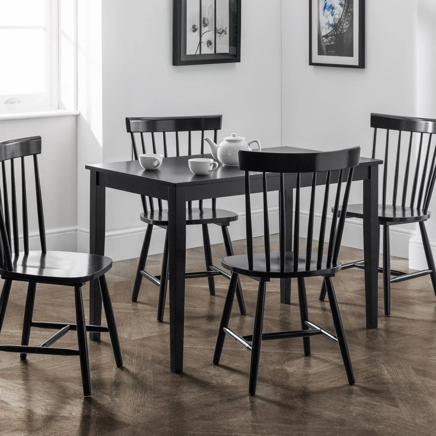 Black dining table with four matching chairs in modern dining room
